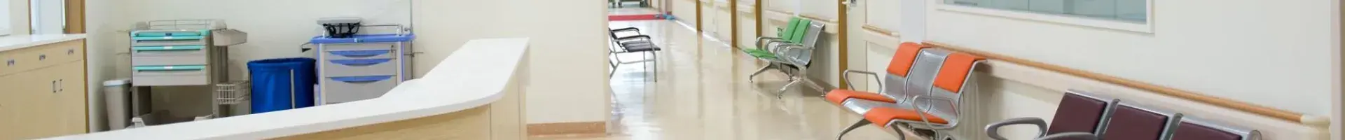 A Medical Office and Waiting Room with Empty Chairs and a Welcome Desk